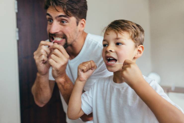 Child flossing before bedtime